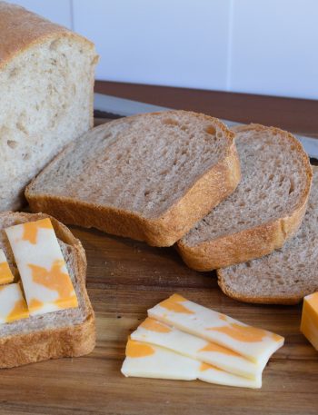 sliced bread laid out on a cutting board with some cheese